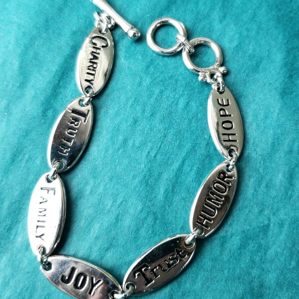 2/15$ Silver tone quality words